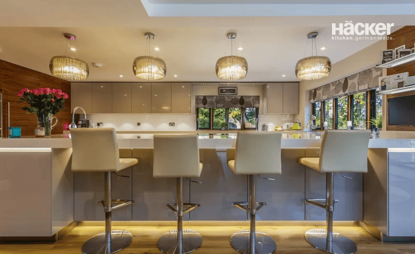 Country house chic kitchen in Woodmancote with shaker-style island and polished marble flooring