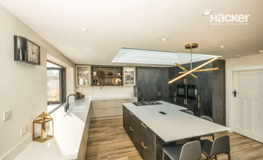Light-filled luxury white kitchen in Shoreham-by-Sea with glass display cabinets and wood flooring