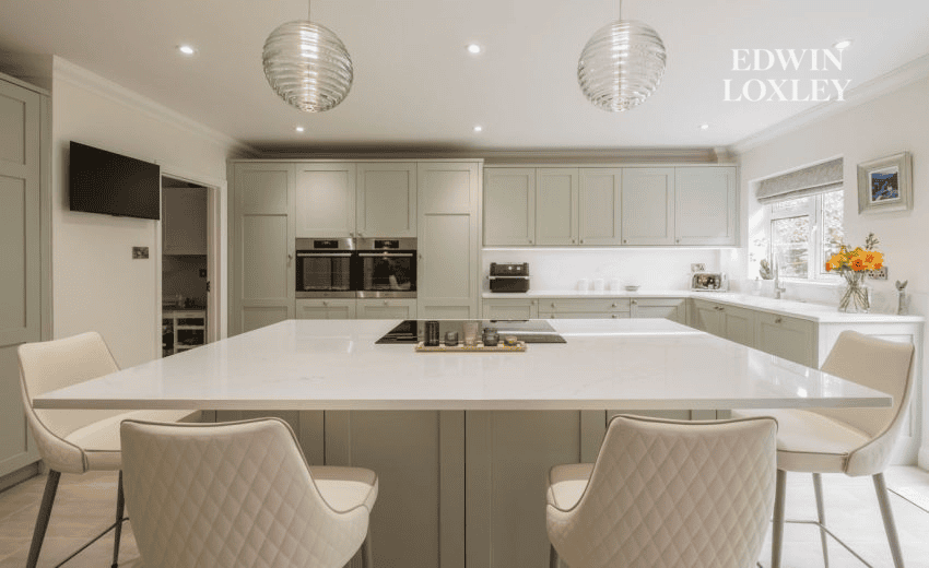 Cream kitchen island opening onto oak-framed garden room extension, Countryside Calm kitchen in Storrington