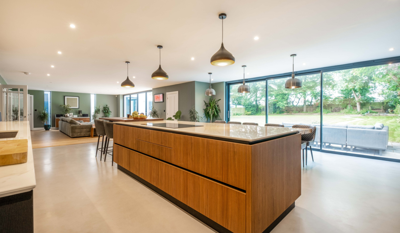 Modern open-plan kitchen island with wood effect cabinets and breakfast bar