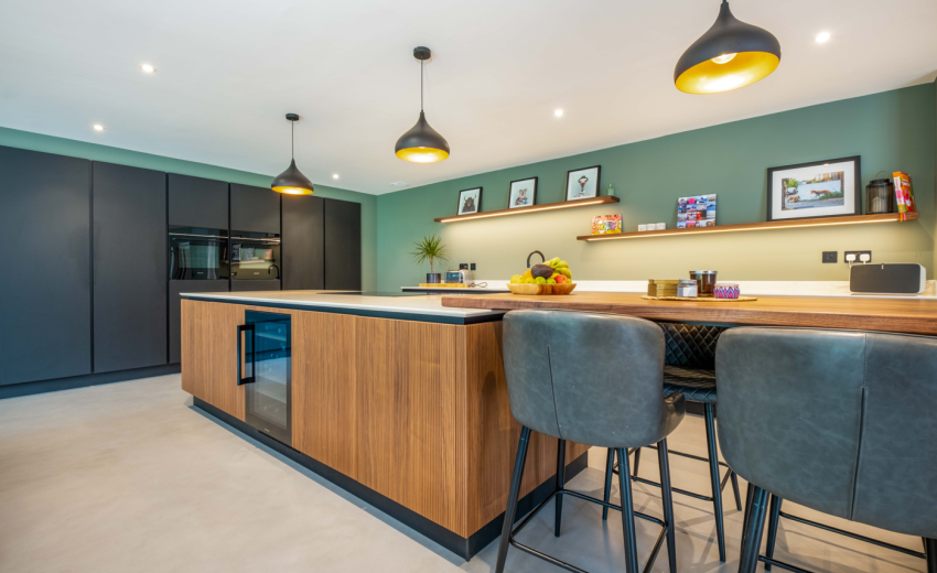 Modern open-plan kitchen island with wood effect cabinets, hob and built-in wine fridge