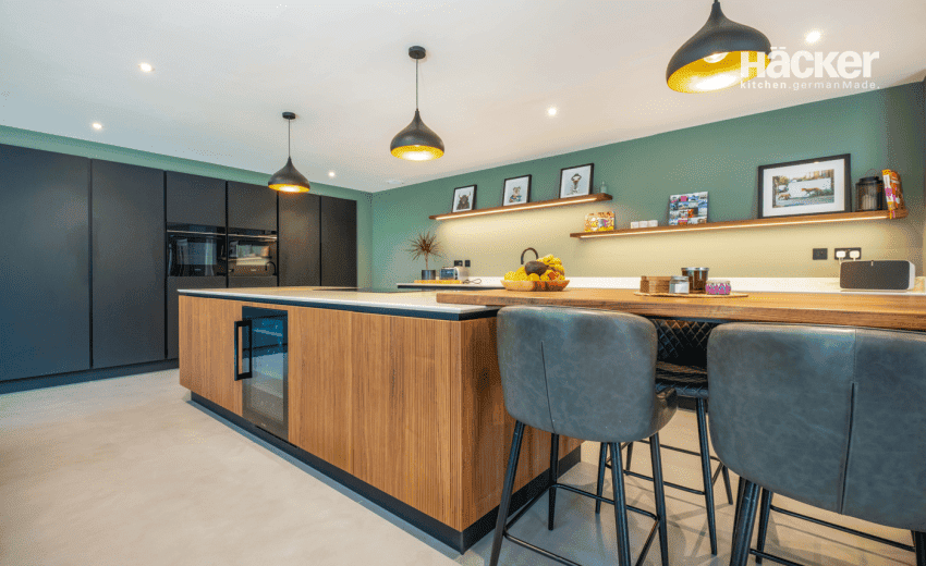 Modern open-plan grey gloss kitchen with island and yellow bar stools, designed by Colliers Kitchens in Worthing, West Sussex
