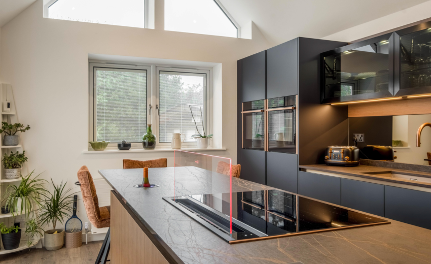 Blue and bronze modern kitchen with island and hob
