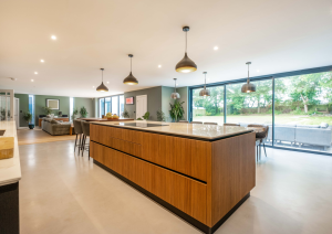 Modern open-plan kitchen island with wood effect cabinets and breakfast bar