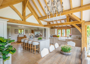 Bespoke shaker kitchen with island and seating and oak beamed ceiling