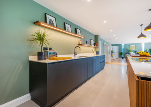 Modern open-plan kitchen sink run with quooker tap and open shelving