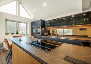 Blue and bronze modern kitchen with island and hob
