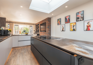 black and white kitchen with exposed brick wall