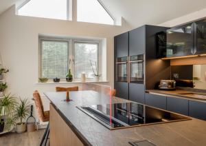 Blue and bronze modern kitchen with island and hob