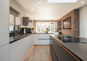 black and white kitchen with exposed brick wall
