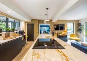 Walnut and matte black modern kitchen with island and yellow stools