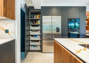 Walnut and matte black modern kitchen with island and larder cupboard