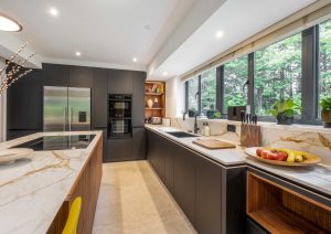 Walnut and matte black modern kitchen with island and yellow stools